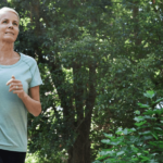 A blonde woman jogging in pleasant weather outdoors